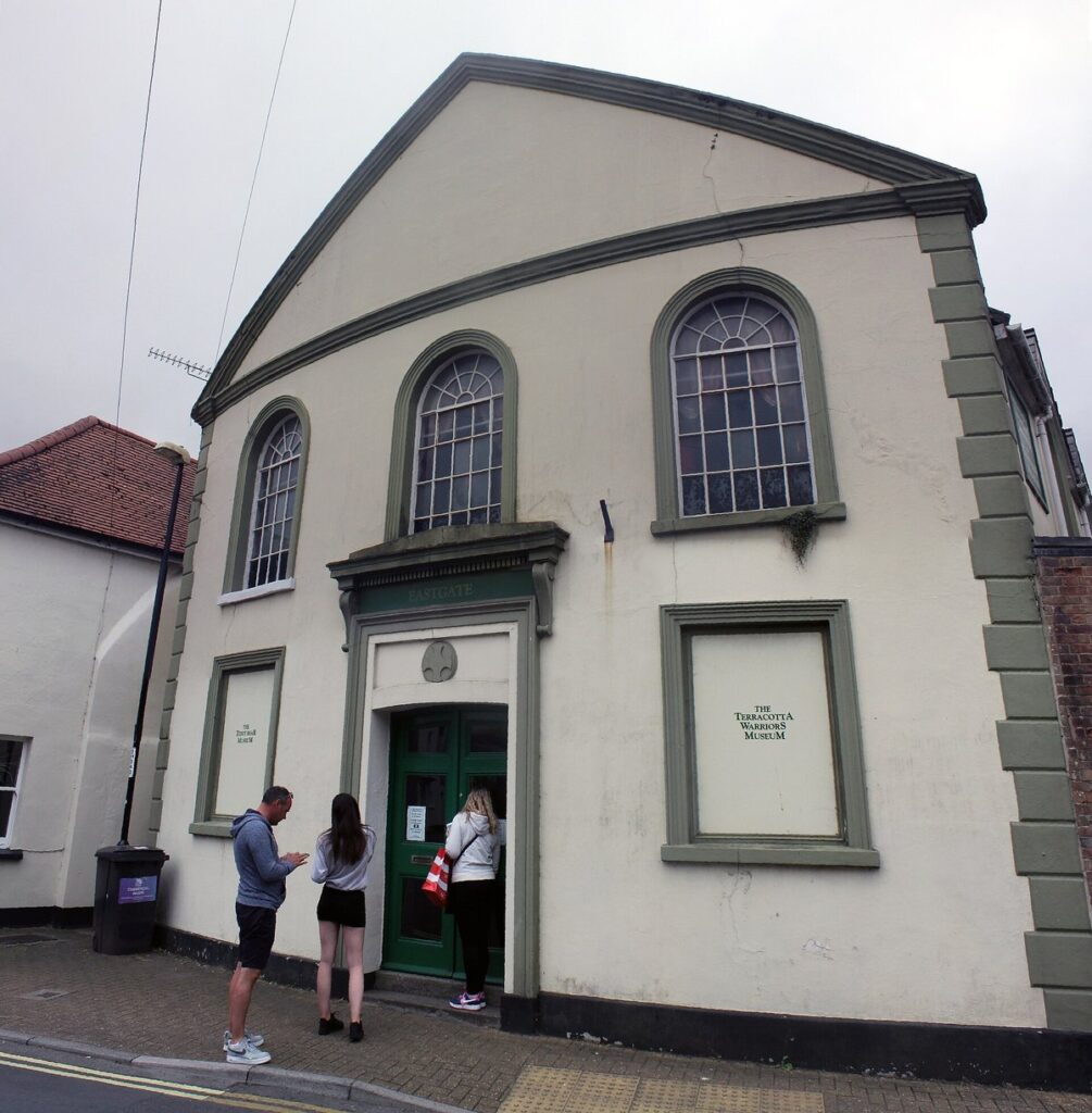 Visitors at the green door of the Dorset Teddy Bear Museum, a white former chapel on Salisbury Street in Dorchester