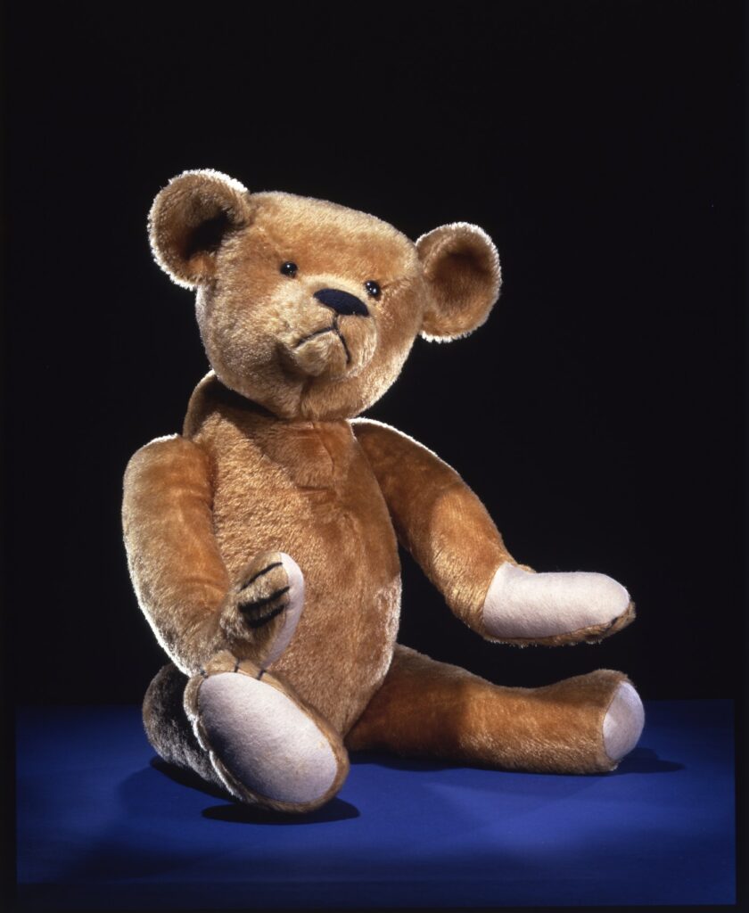 Early Ideal Toy Company teddy bear from about 1903, seated, in the Smithsonian collection