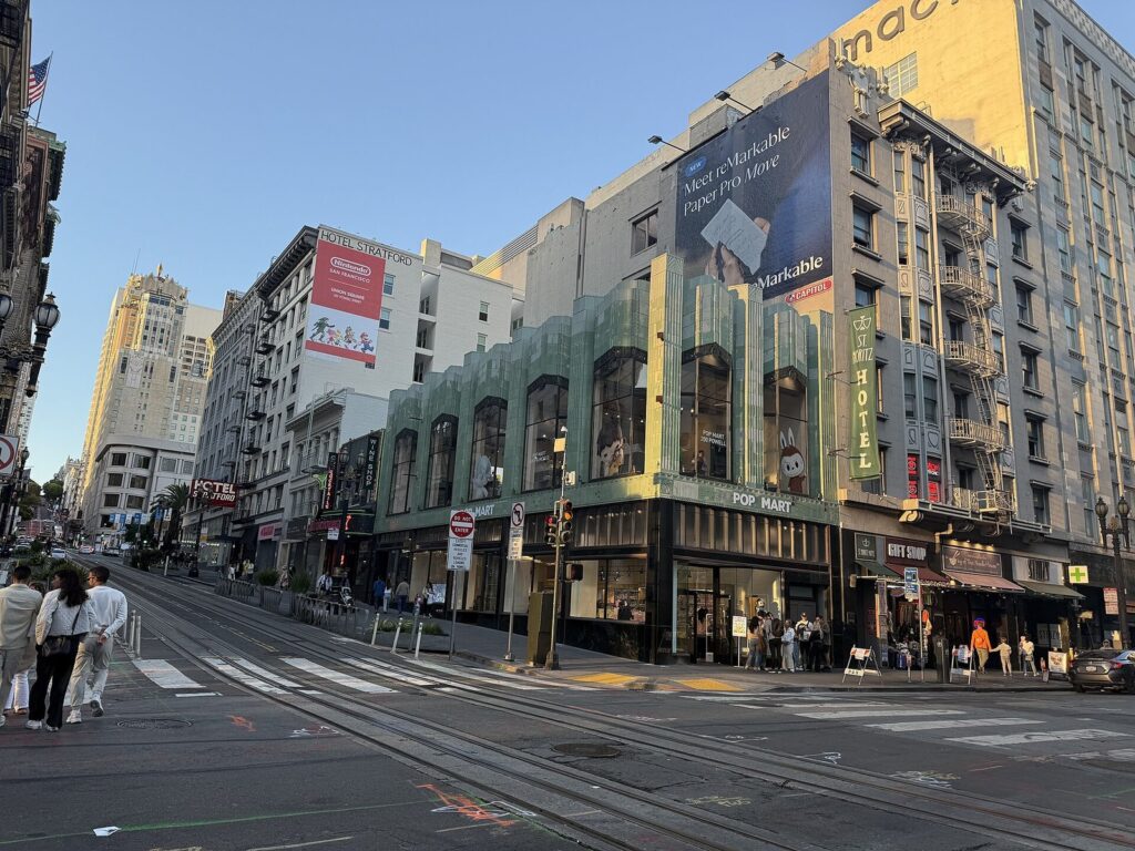 Street corner in San Francisco with a newly opened Pop Mart store on the ground floor of a historic building