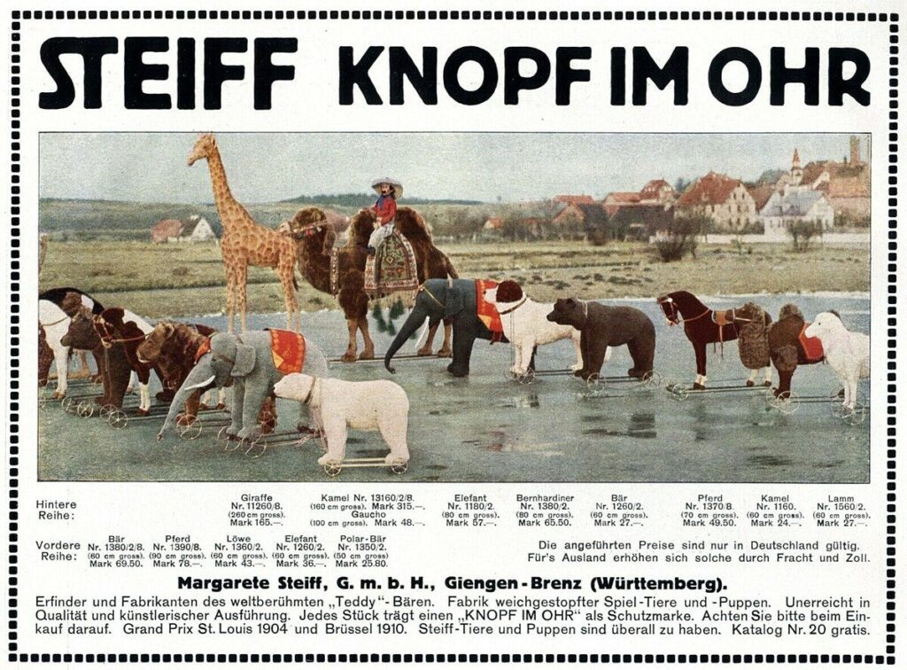 1913 Steiff advertisement headed Knopf im Ohr showing a row of large plush animals on wheels, with model numbers and prices