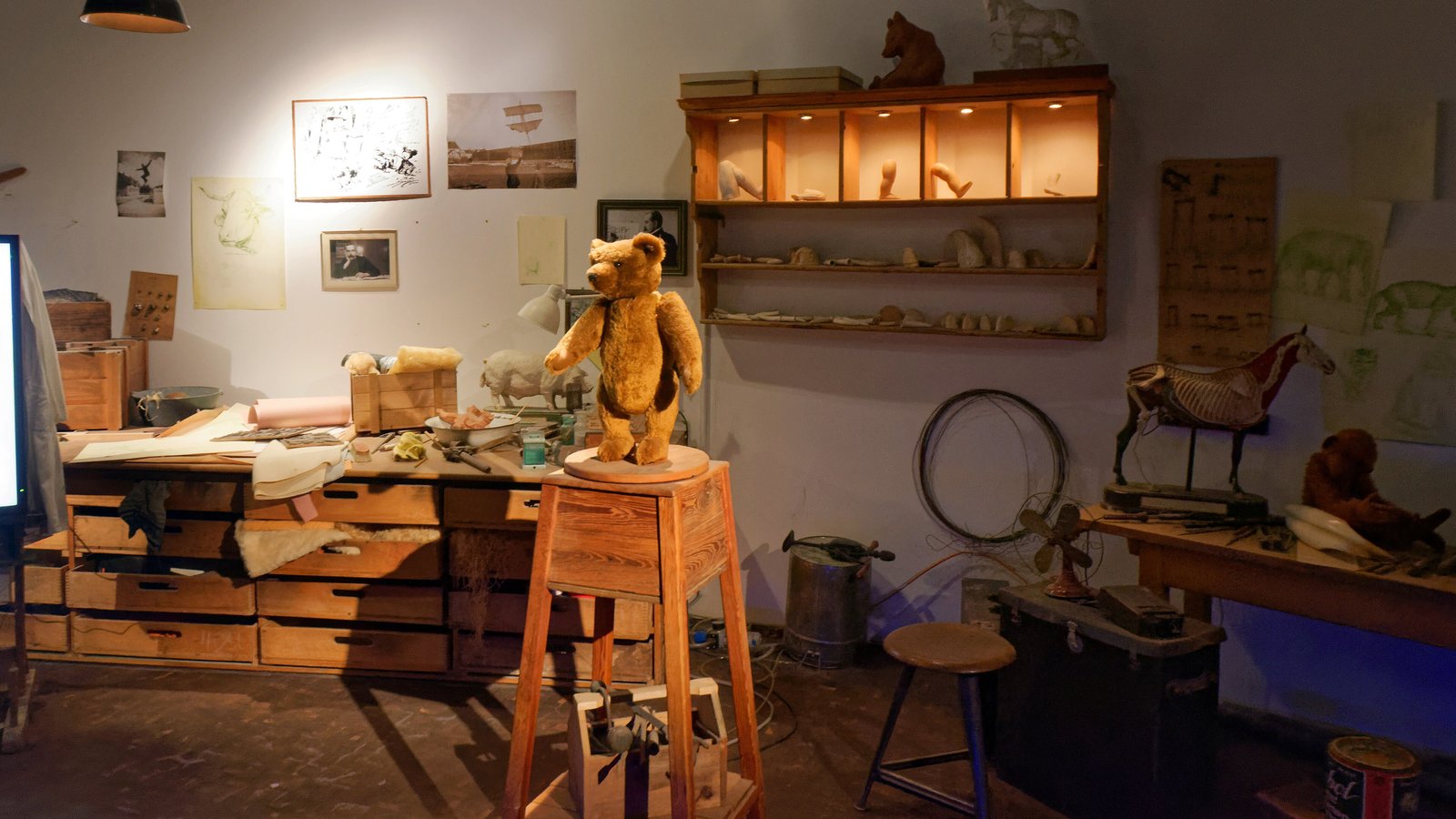 Recreated toy workshop display with a jointed teddy bear on a stool inside the Steiff Museum in Giengen, Germany