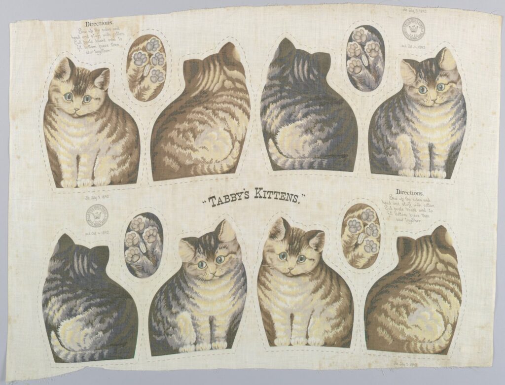 Uncut 1892 cotton panel printed with front, back, and base pieces for four striped kittens, with sewing directions